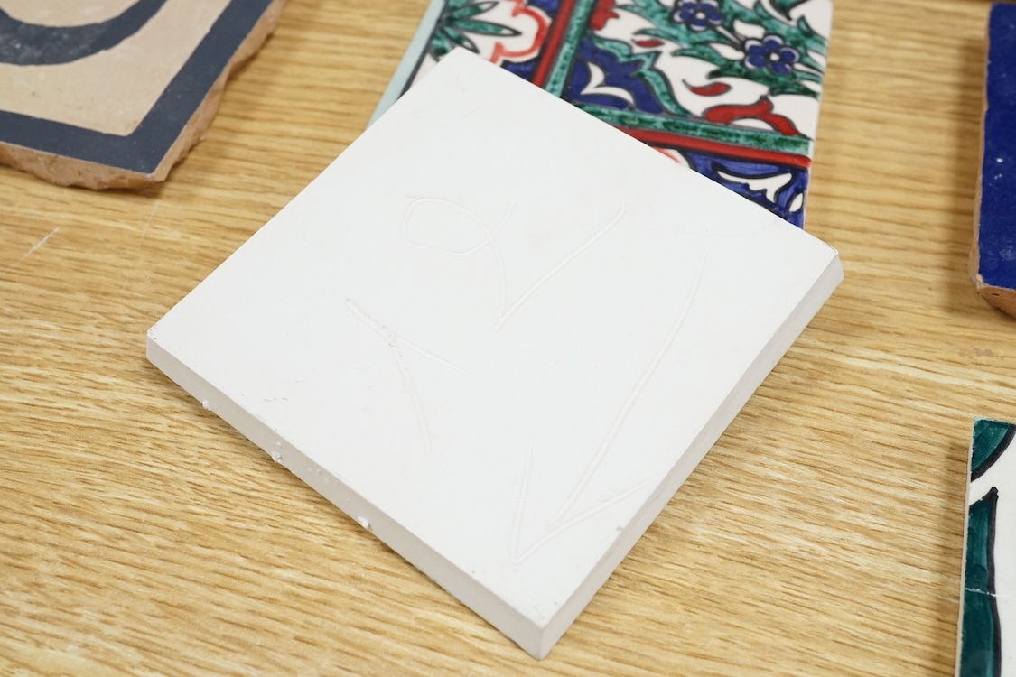 A Berber sixteen tile set, North African to read 'God is Great', floral tiles 10cm square